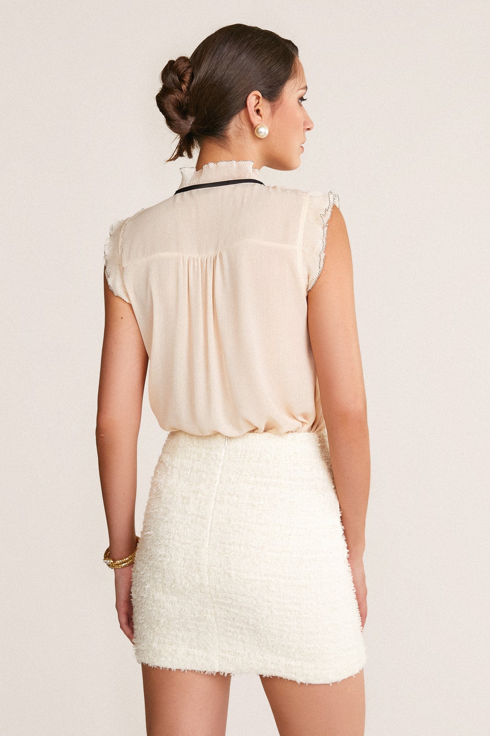 Ivory Sleeveless Ruffled Tie Neck Blouse
