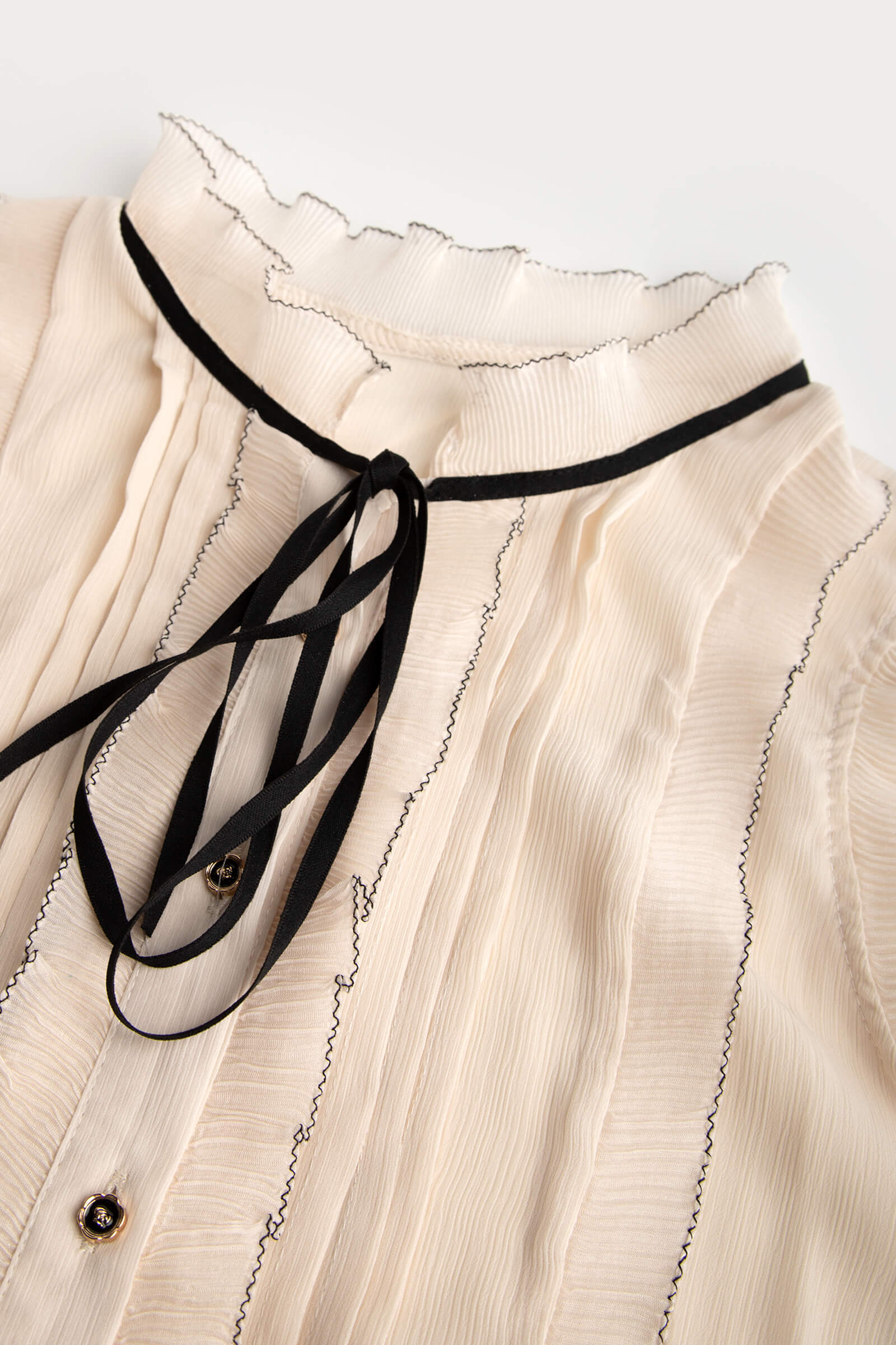 Ivory Sleeveless Ruffled Tie Neck Blouse