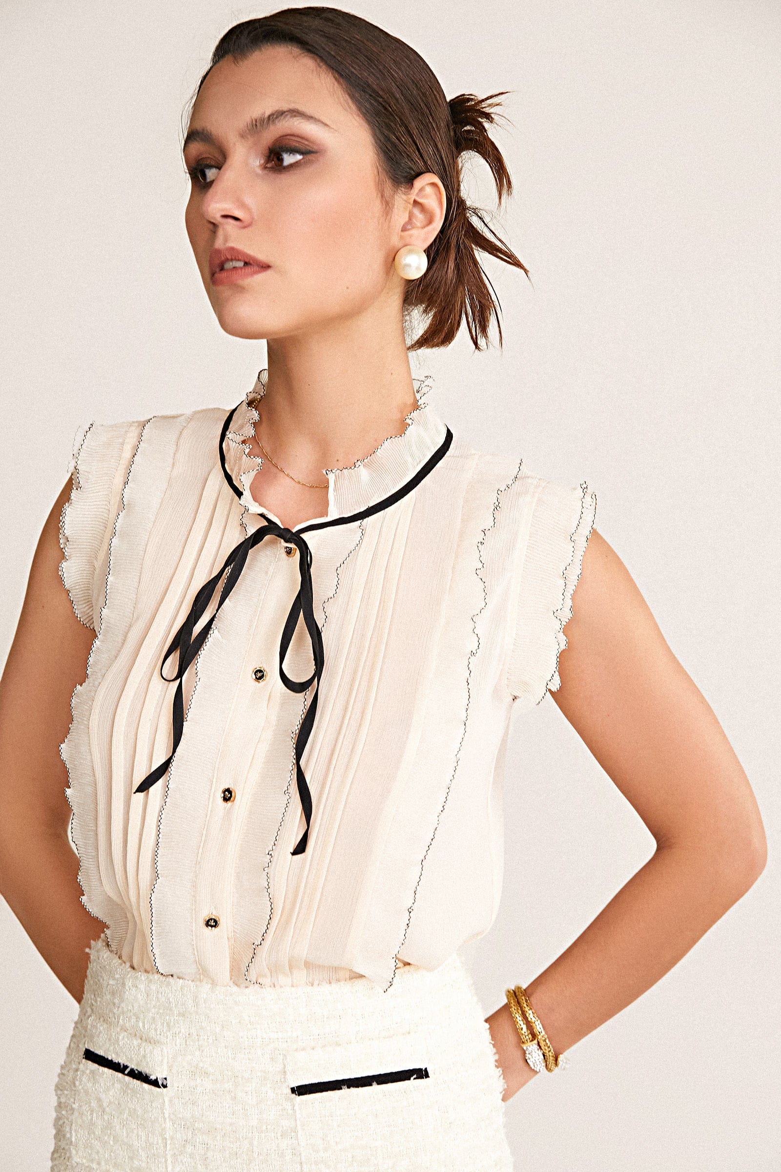 Ivory Sleeveless Ruffled Tie Neck Blouse